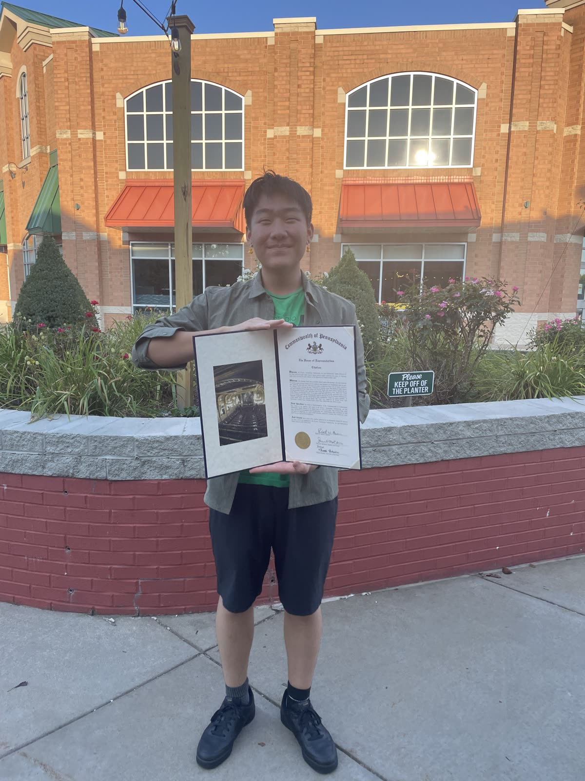 David Mao holding the Pennsylvania House of Representatives citation